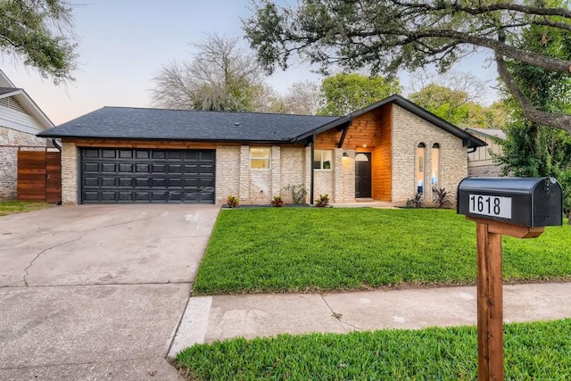 view of front of house with a garage and a yard