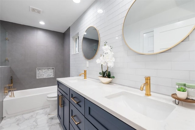 full bathroom featuring vanity, backsplash, shower / washtub combination, toilet, and tile walls