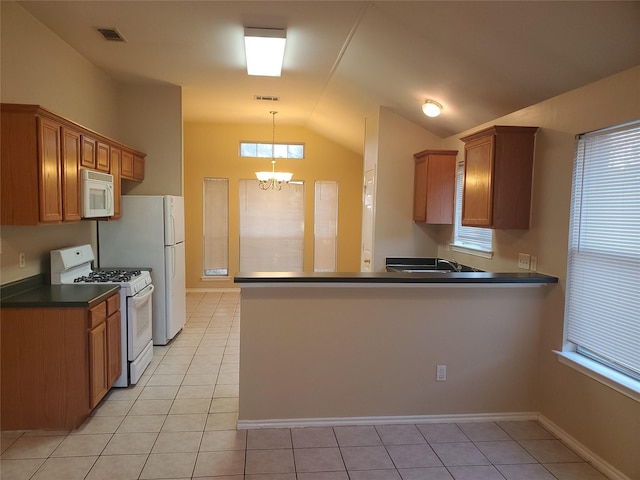 kitchen with white appliances, kitchen peninsula, a notable chandelier, and light tile patterned floors