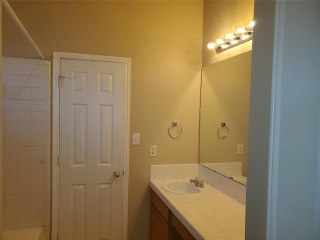 bathroom featuring a shower and vanity