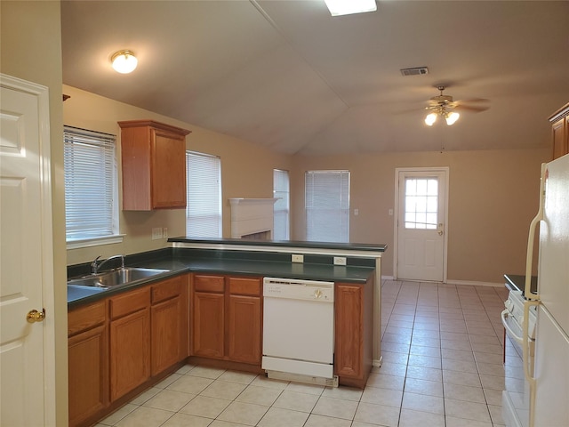 kitchen featuring white appliances, vaulted ceiling, light tile patterned floors, ceiling fan, and sink