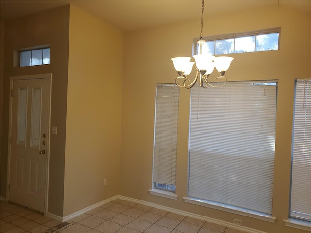 unfurnished dining area featuring an inviting chandelier and light tile patterned flooring