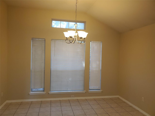 tiled empty room featuring lofted ceiling and a notable chandelier