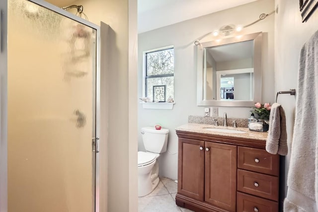 bathroom featuring toilet, vanity, tile patterned floors, and an enclosed shower