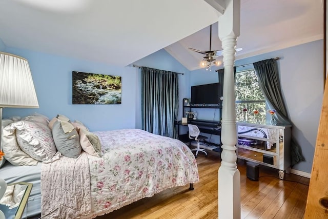 bedroom featuring hardwood / wood-style flooring, ceiling fan, and lofted ceiling