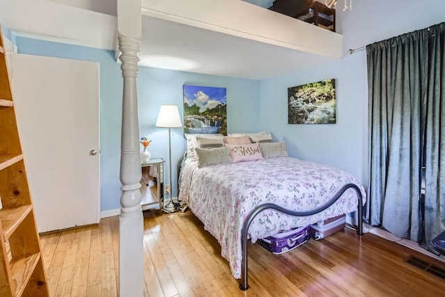 bedroom with hardwood / wood-style floors