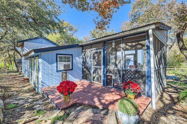 view of outdoor structure with a sunroom