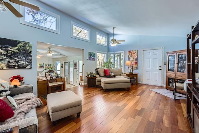 living room featuring ceiling fan, hardwood / wood-style floors, and high vaulted ceiling