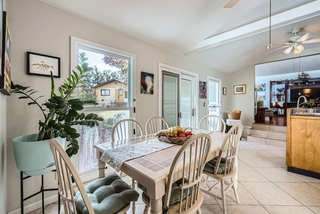 tiled dining room with vaulted ceiling and ceiling fan