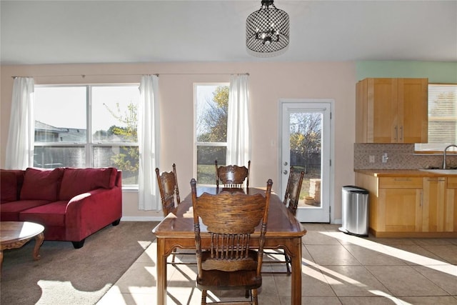 tiled dining area featuring sink