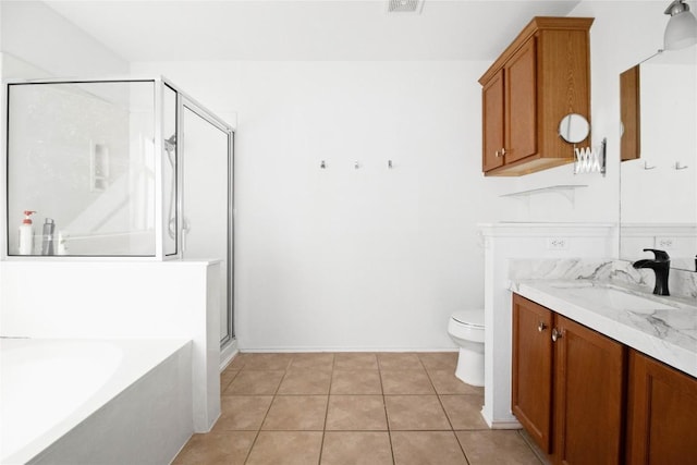 full bathroom featuring tile patterned floors, vanity, toilet, and independent shower and bath