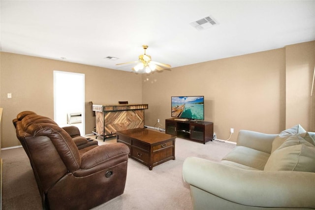 carpeted living room featuring ceiling fan