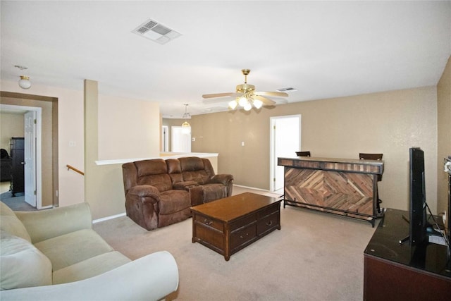 carpeted living room featuring ceiling fan