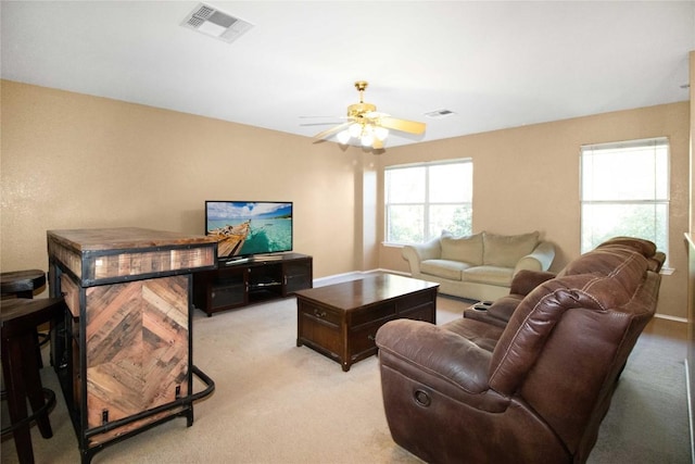 living room with light colored carpet and ceiling fan