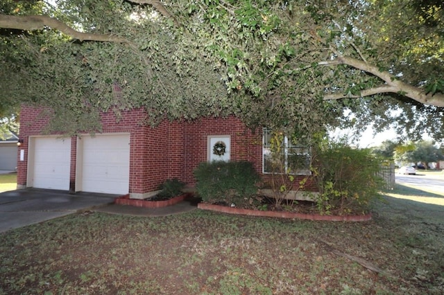 view of property hidden behind natural elements featuring a garage