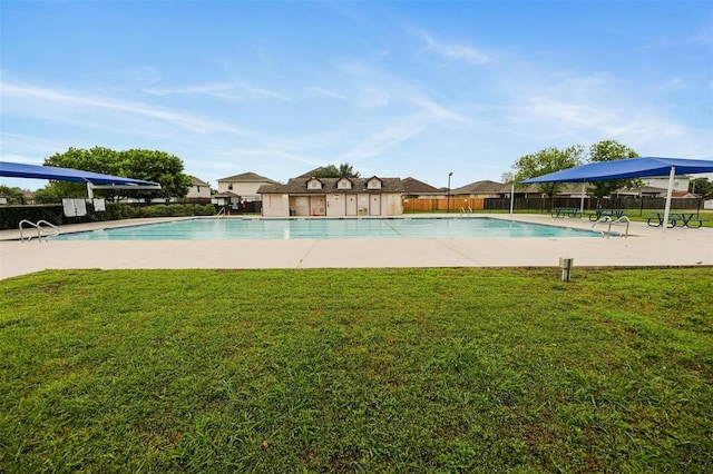 view of pool with a lawn