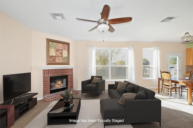 carpeted living room featuring ceiling fan and a brick fireplace