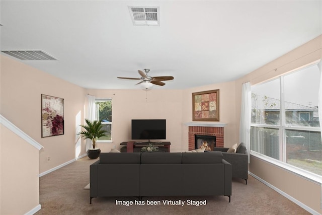 living room with light carpet, a brick fireplace, and ceiling fan