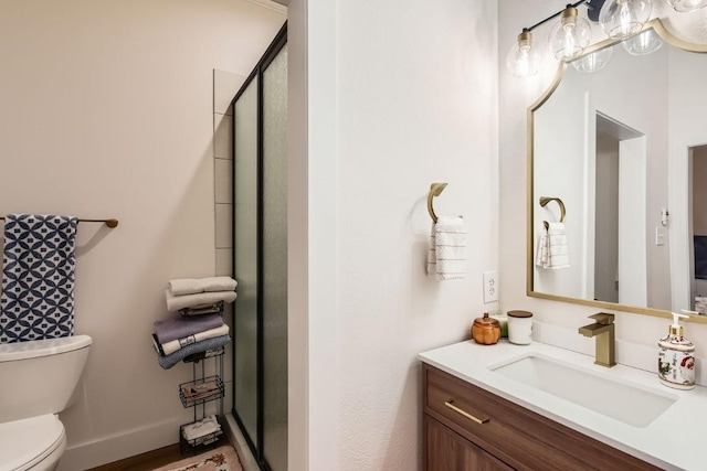 bathroom featuring vanity, toilet, and walk in shower