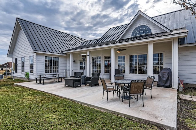 back of property with a lawn, ceiling fan, an outdoor hangout area, and a patio