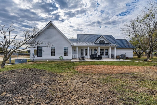 rear view of house featuring a yard, a patio, and central AC unit