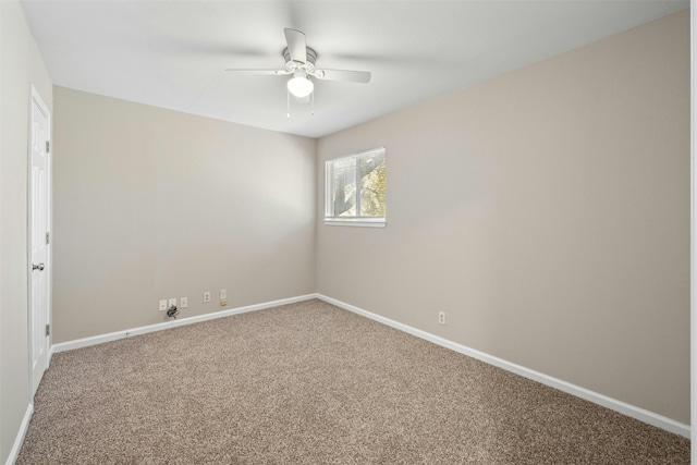 spare room featuring carpet flooring and ceiling fan