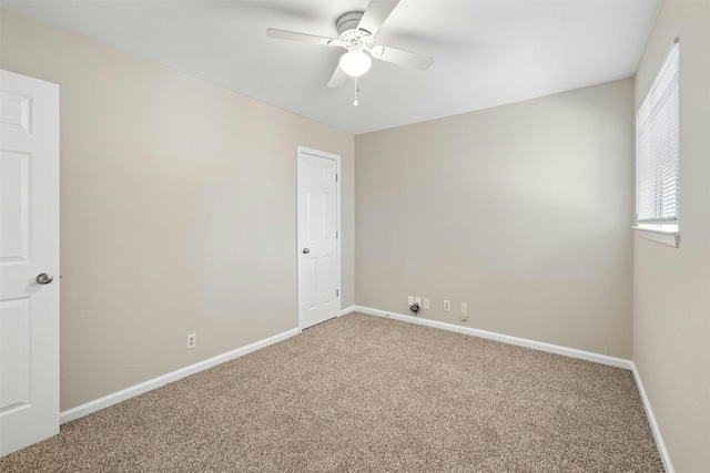 empty room with carpet flooring and ceiling fan