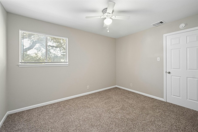 unfurnished room featuring ceiling fan and carpet floors