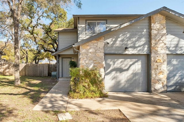 front facade with a garage and cooling unit