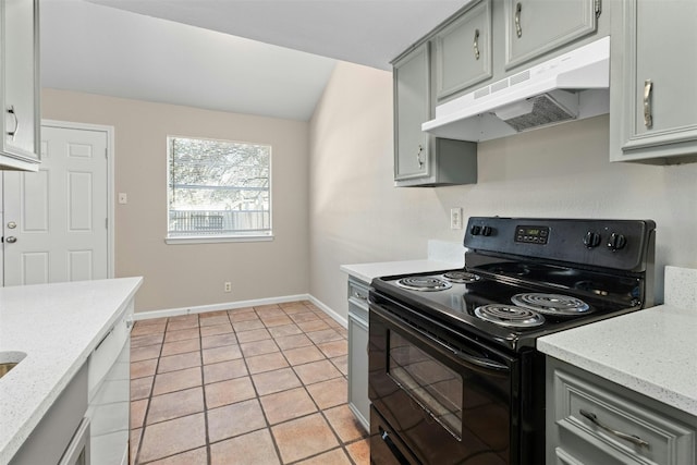 kitchen featuring electric range, gray cabinets, light stone countertops, and light tile patterned floors