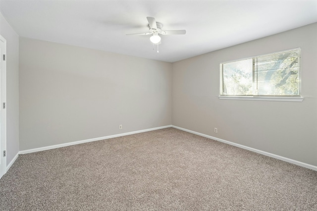 spare room featuring carpet and ceiling fan