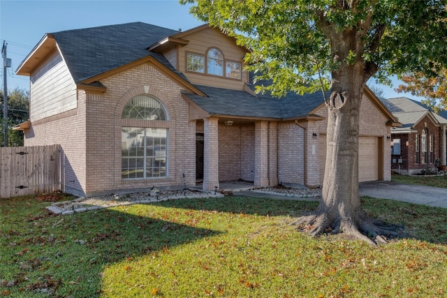 view of front of property featuring a front yard and a garage