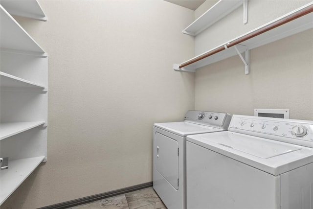 laundry room featuring washer and dryer, laundry area, baseboards, and marble finish floor