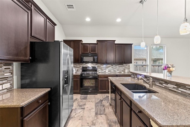 kitchen with backsplash, sink, black appliances, and decorative light fixtures