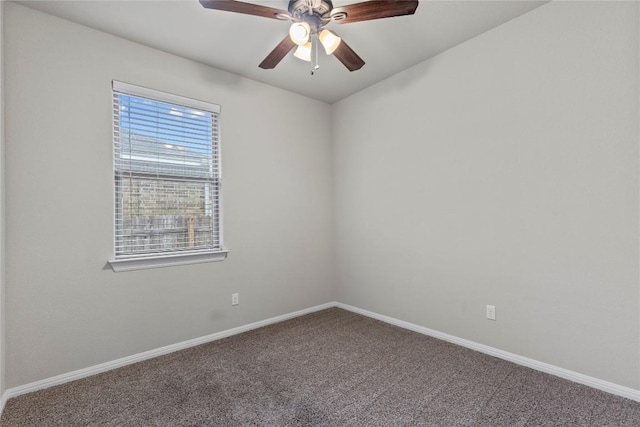 carpeted spare room featuring ceiling fan