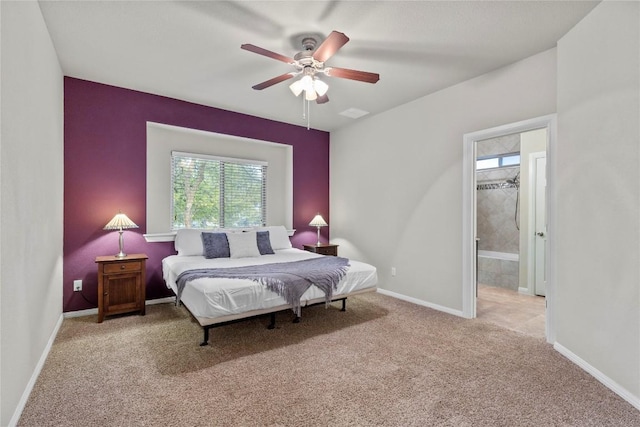 carpeted bedroom with ceiling fan and ensuite bathroom