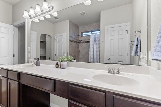 bathroom with a shower with curtain and vanity