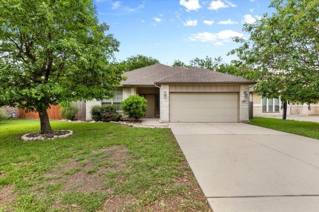 single story home featuring a garage, stone siding, a front yard, roof with shingles, and concrete driveway