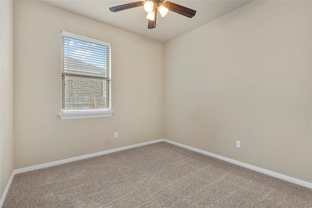 carpeted empty room with baseboards and a ceiling fan