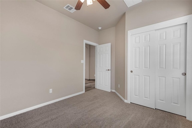 unfurnished bedroom with ceiling fan, visible vents, baseboards, a closet, and carpet flooring