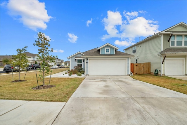 view of front of property featuring a front lawn and a garage