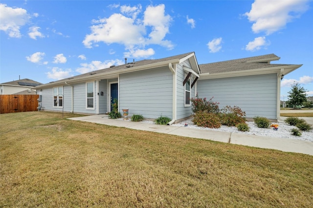 rear view of property featuring a lawn