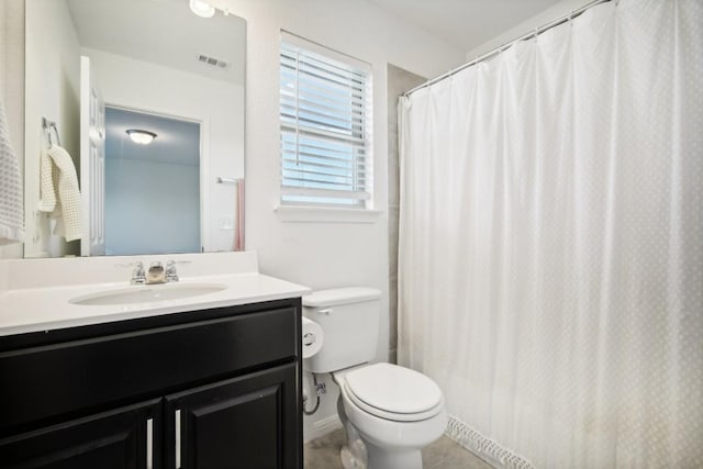 bathroom with tile patterned flooring, vanity, and toilet