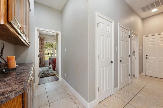 corridor with light tile patterned flooring