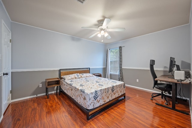 bedroom with ceiling fan, hardwood / wood-style floors, and crown molding