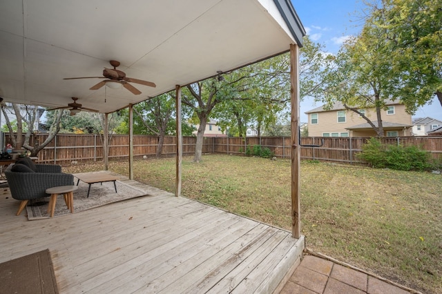 deck featuring ceiling fan and a yard