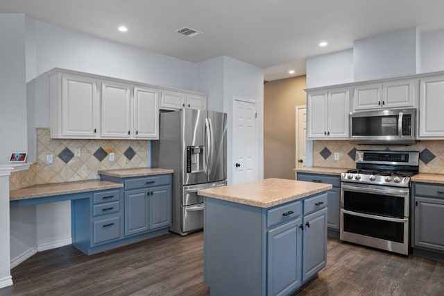 kitchen featuring white cabinets, a center island, dark wood-type flooring, and appliances with stainless steel finishes