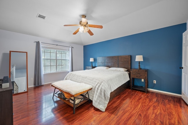 bedroom with ceiling fan and dark hardwood / wood-style floors