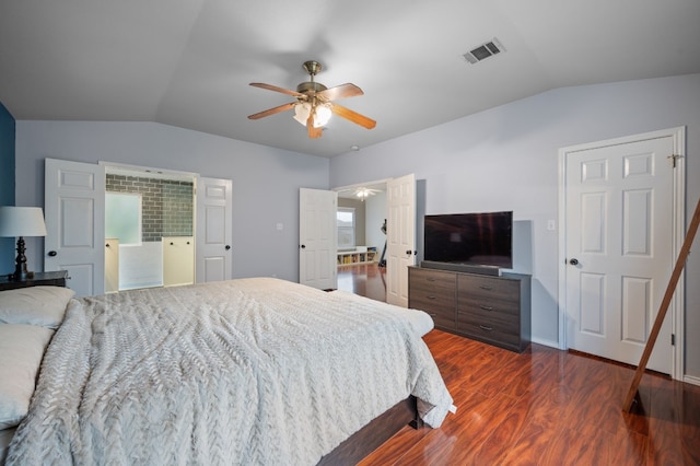 bedroom with ceiling fan, dark wood-type flooring, and vaulted ceiling