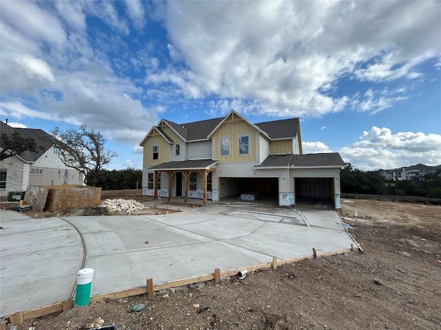 view of front of property featuring a porch and a garage